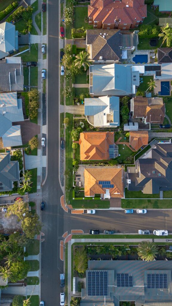 Aerial photo of suburban street and houses in Collaroy, NSW, showcasing colorful rooftops and greenery.