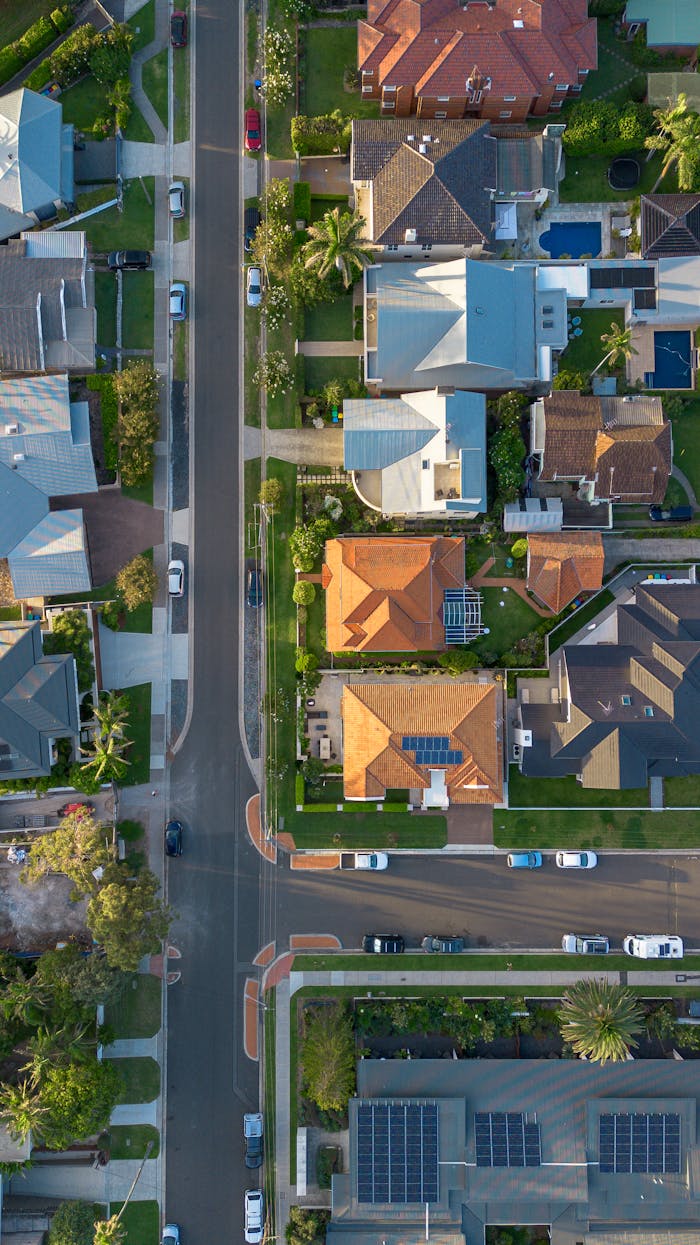 Aerial photo of suburban street and houses in Collaroy, NSW, showcasing colorful rooftops and greenery.